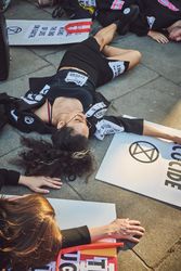London, England, United Kingdom - September 15th,2019: Female protestor lying on street among signs