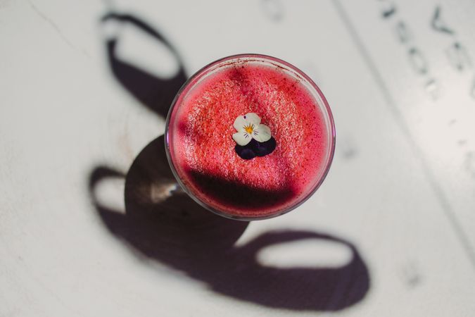 Delicious pink smoothie with frothy in glass