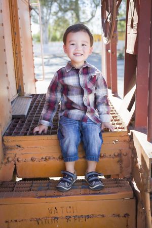 Cute Young Biracial Boy Having Fun on Railroad Car