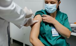 Female surgeon receiving coronavirus vaccine