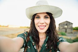 Smiling brunette female taking a selfie