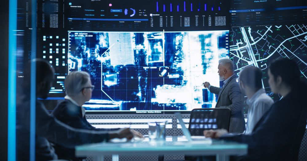 Team of Surveillance Experts Having a Discussion During a Meeting in an Advanced Research Center.