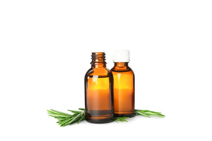 Rosemary oil in jars isolated on neutral background
