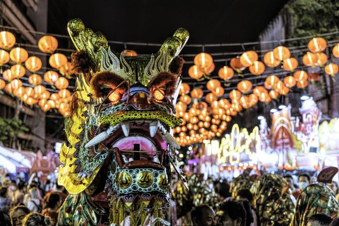 Dragon dance performed by people parading the street during night time in Bangkok, Thailand