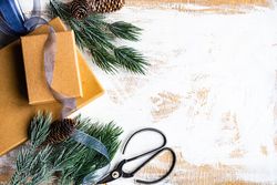 Christmas card concept with top view of gift boxes and tree branch with copy space