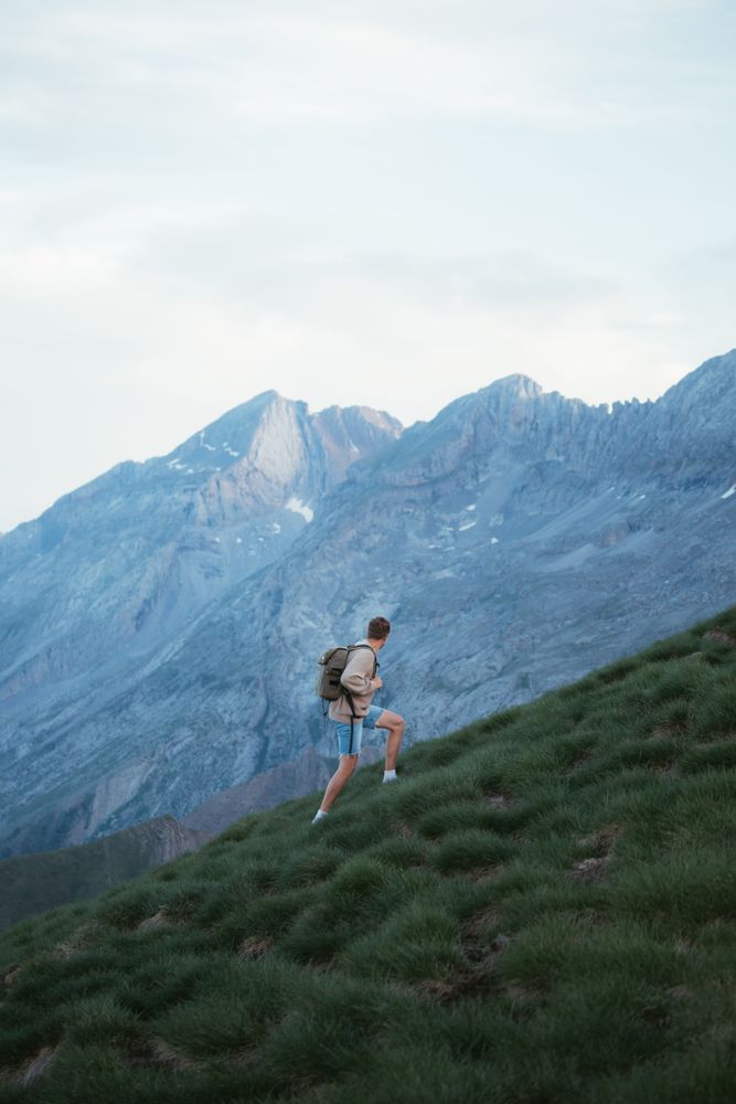 Unrecognizable man with backpack hiking in Pyrenees mountains