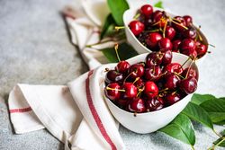 Sweet cherries in bowls on kitchen counter