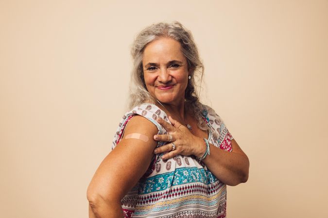 Older woman looking happy after getting vaccine