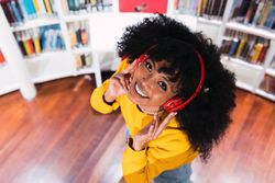 Portrait of cheerful Black woman in headphones