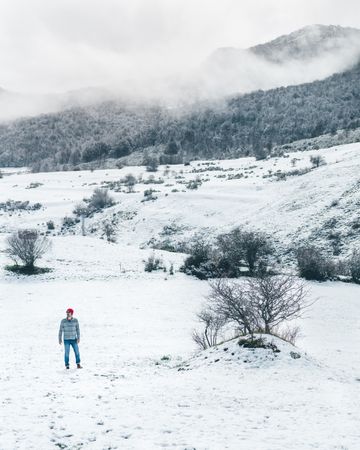 Man walking on winter field