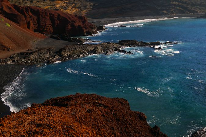 Beautiful and picturesque view of surface of sea water among high rocky cliffs on sunny day