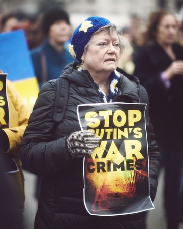 London, England, United Kingdom - March 5 2022: Older woman with “Stop Putin’s War Crimes” sign