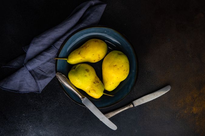 Top view of pears on navy plate