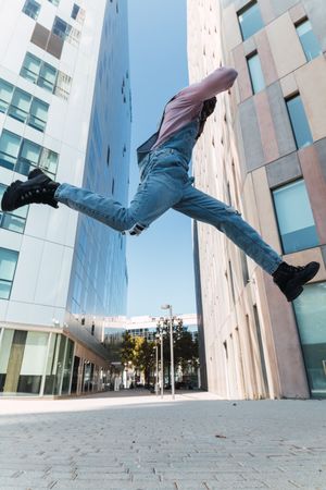 Excited Black man enjoying music in city