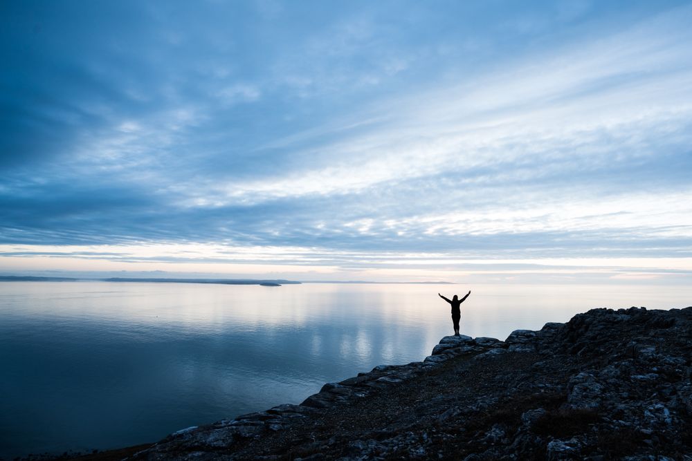 Happy man on rocky coastline