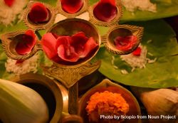 Rose petals on golden panch aarti on a table 4A9vY4