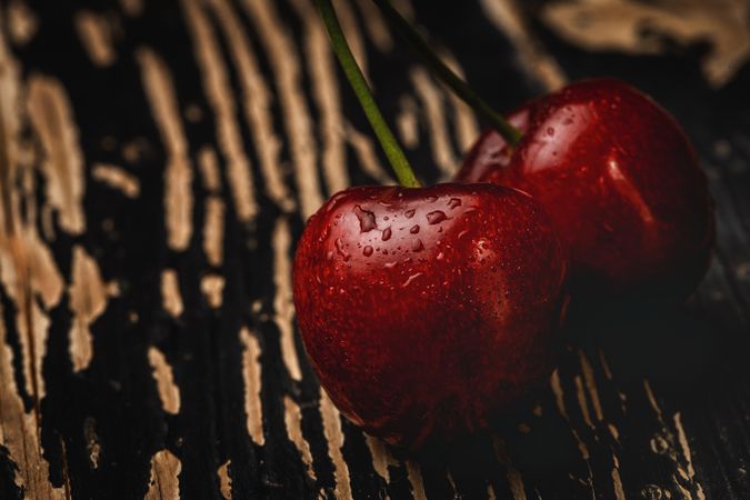 Red ripe cherry with stem on wooden stand