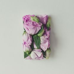 Pink flowers in shape of a gift box on light  background