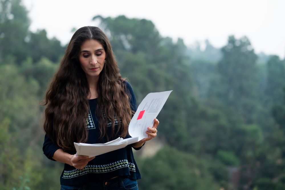 Female director reviewing the script outside