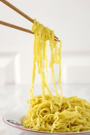Close Up Thin Yellow Noodle with Chopstick