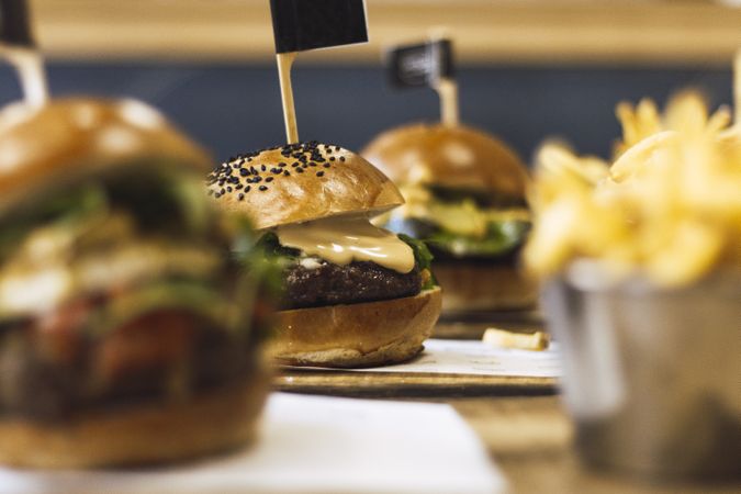 Juicy delicious burger and fried potato on table