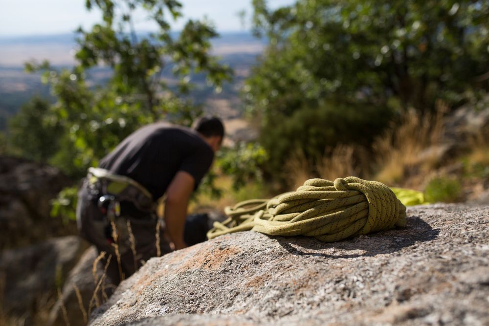A climber is preparing his ropes to start climbing