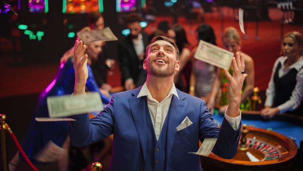 Happy Man in a Suit Standing in the Middle of a Modern Casino