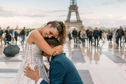 Bridegroom kneeling and kissing bride