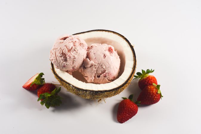 Top view of coconut shell with delicious ice cream and strawberry fruit