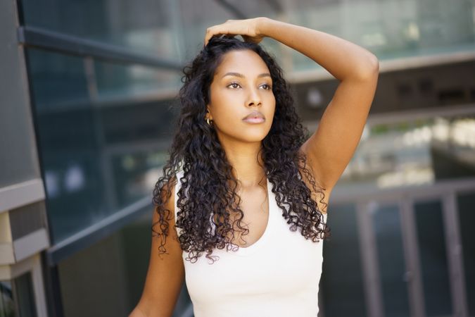 A Stylish and Elegant Young Woman Posing Gracefully Outdoors with Confidence and Poise