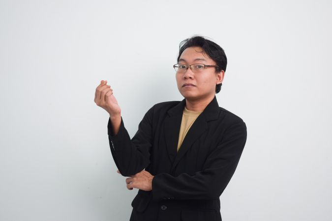Asian Businessman asking for money with hand sign