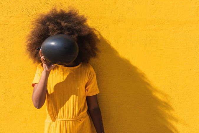 Black girl with black balloons