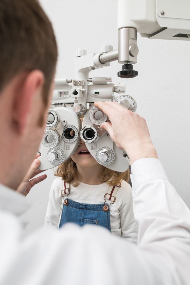 Optician testing a girl's eyes