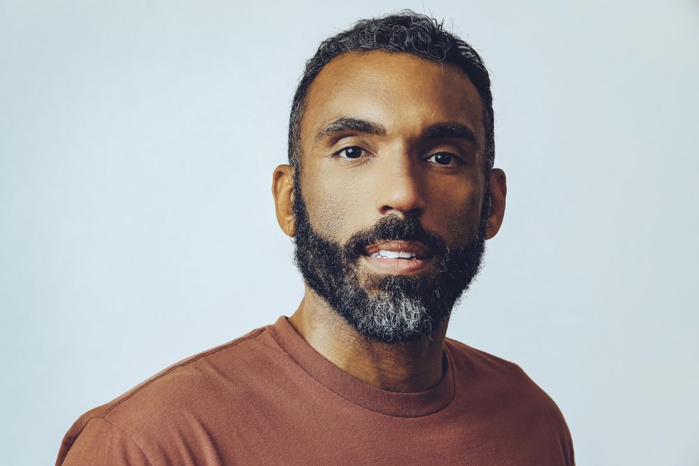 Head shot of serious Black male in grey studio