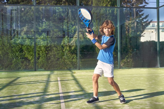 Boy playing padel on playground