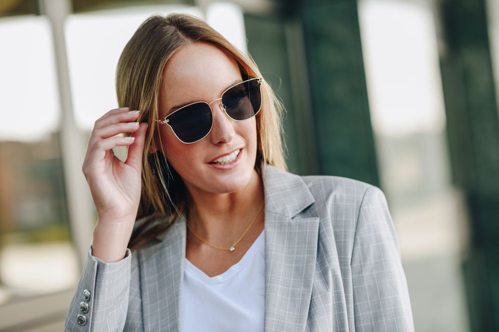 Woman adjusting sunglasses