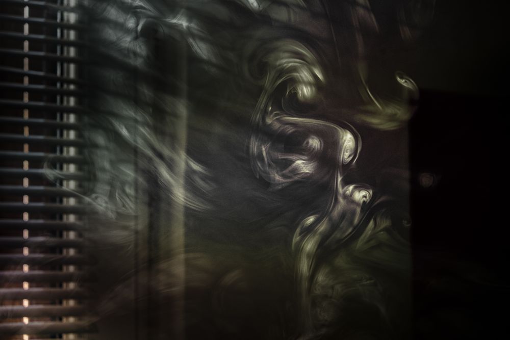 Smoke and light coming in through the blinds