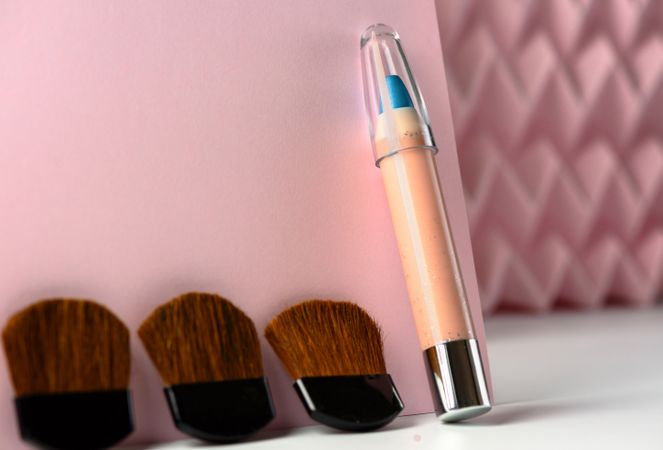 Cosmetic pencils:, make up blue eyeliner pencil, modern background with pink chevron reliefs. make up concept