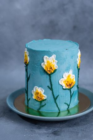 Teal cake decorated with buttercream flowers