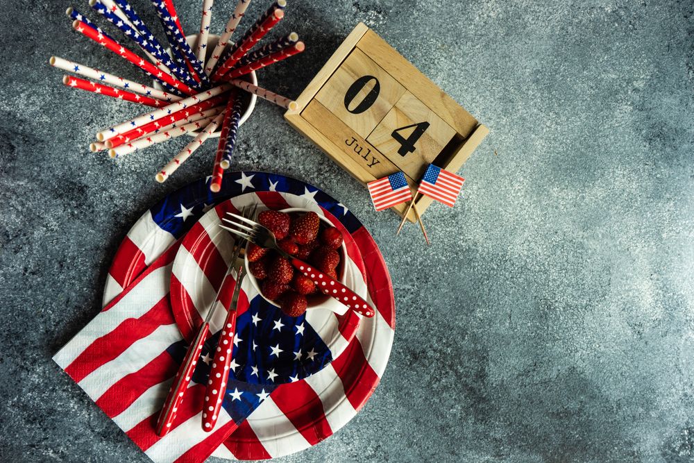 Independence Day celebration table setting on grey counter with strawberries with copy space