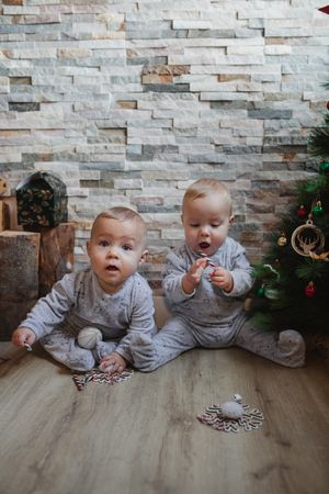 Babies examining Christmas presents at home