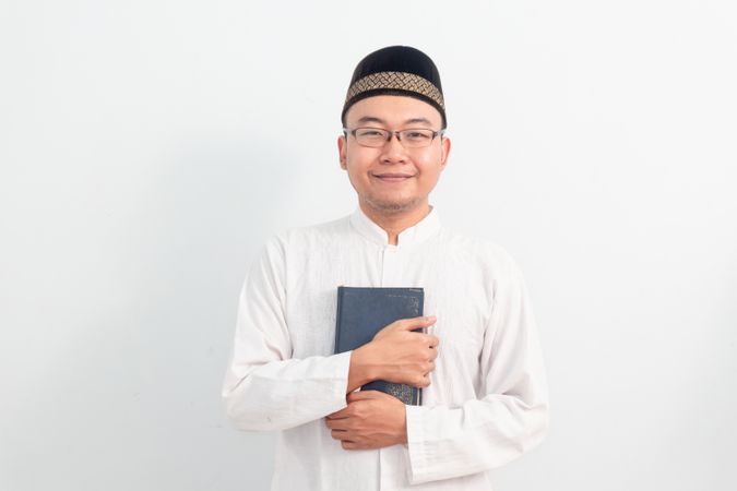 Asian Muslim man  holding quran during Ramadan