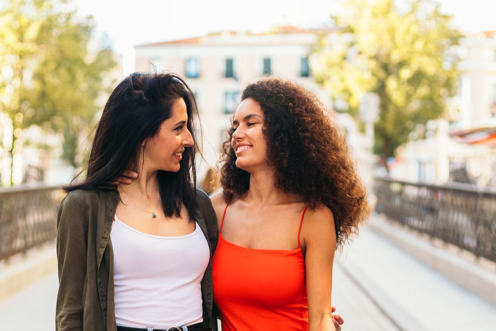 two young women looking each other