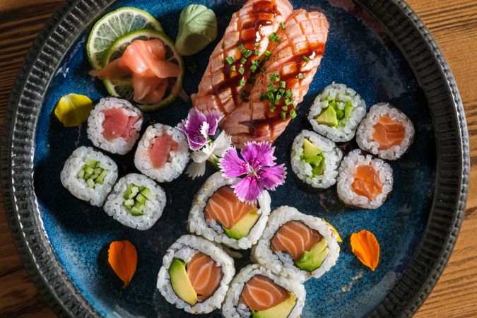 Assorted sushi rolls on ceramic plate