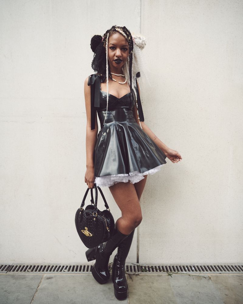 London, England, United Kingdom - September 18 2021: Woman in PVC dress and heart handbag
