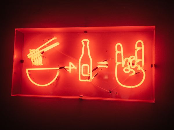 Neon signboard on red background