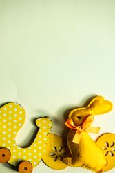 Easter holiday card concept with yellow rabbit and egg ornaments