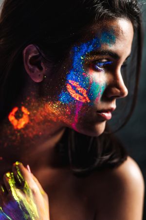 Young woman covered with uv painting