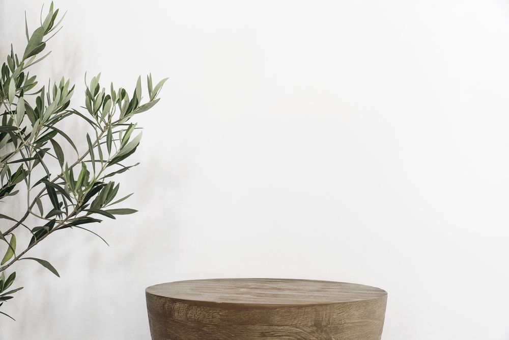 Wooden stool next to branches indoors