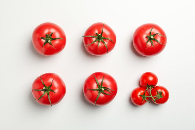 Flat lay with ripe tomatoes on neutral background, top view